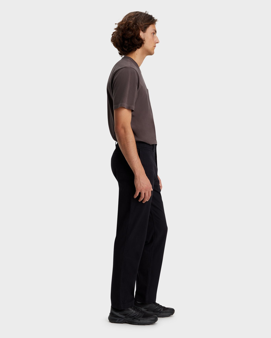 Side view of model wearing Beautiful Black Alpha Chino Pants, Straight Fit.