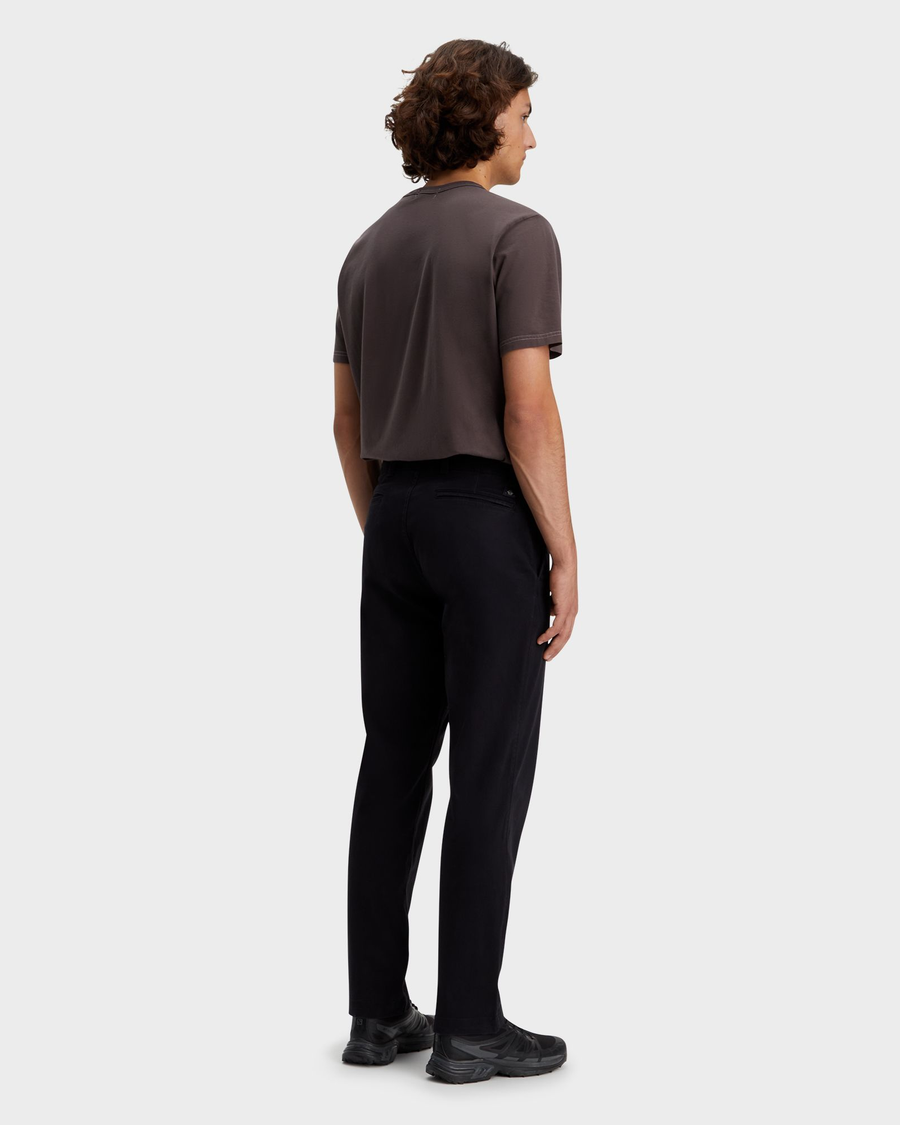 Back view of model wearing Beautiful Black Men's Straight Fit Smart 360 Flex California Chino Pants.