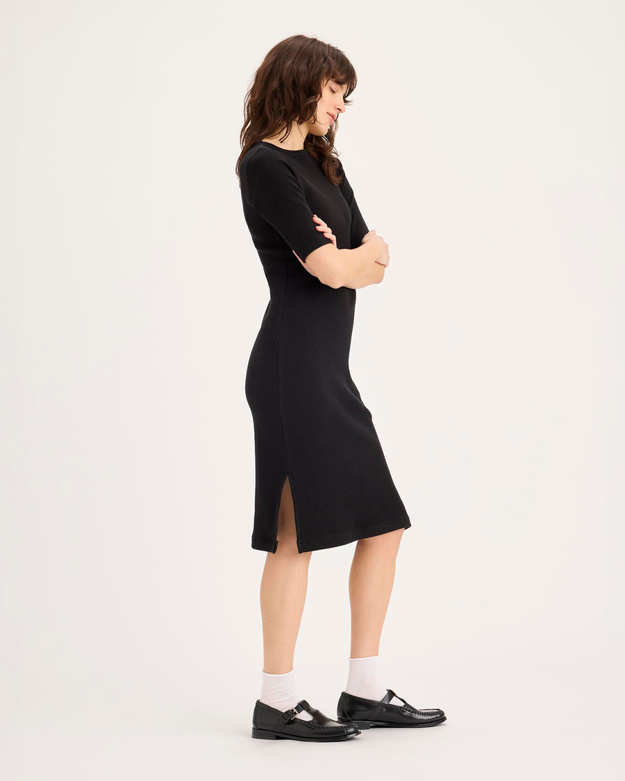 Side view of model wearing Beautiful Black Rib Dress with Lofi Knit, Slim Fit.