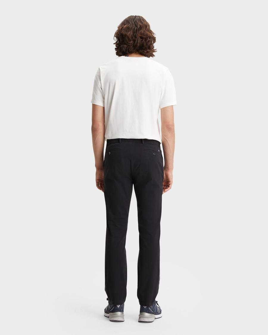 Back view of model wearing Black Men's Slim Fit Smart 360 Flex Alpha Chino Pants.