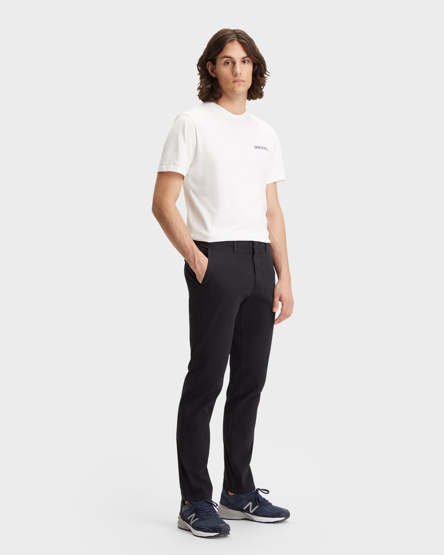 Front view of model wearing Black Men's Slim Fit Smart 360 Flex Alpha Chino Pants.