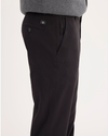 Side view of model wearing Black Ultimate Chinos, Slim Fit.