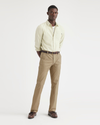 Front view of model wearing British Khaki Men's Slim Fit Smart 360 Flex Workday Khaki Pants.