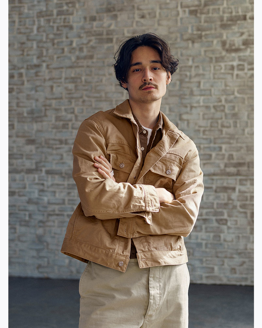 View of model wearing Broad Khaki Dockers® x Transnomadica Officer Shirt.