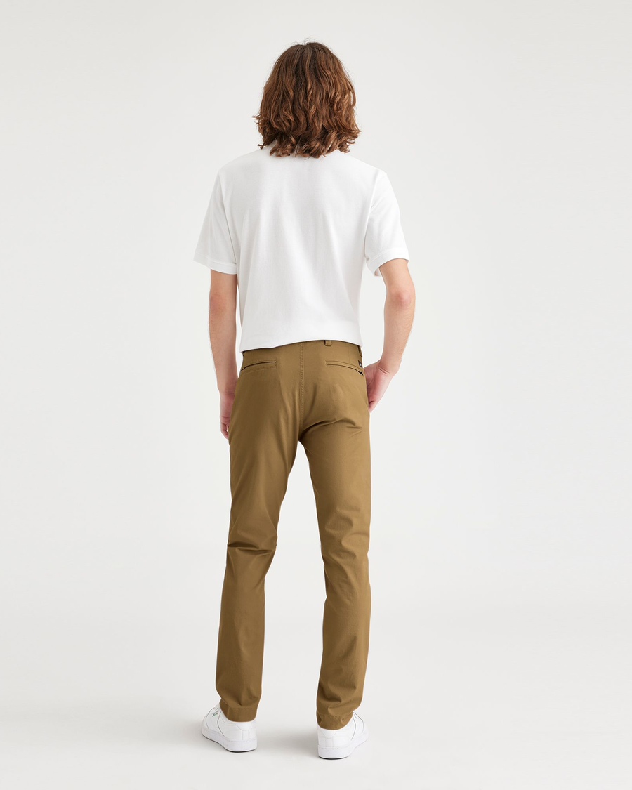 Back view of model wearing Bronze Brown Alpha Chino Pants, Skinny Fit.