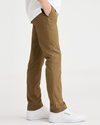 Side view of model wearing Bronze Brown Alpha Chino Pants, Skinny Fit.