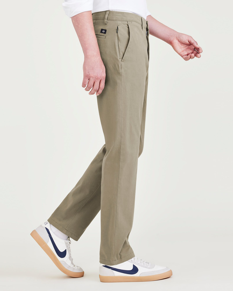 Side view of model wearing Camo Men's Slim Fit Smart 360 Flex Alpha Chino Pants.