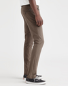 Side view of model wearing Coffee Quartz Men's Skinny Fit Supreme Flex Alpha Khaki Pants.