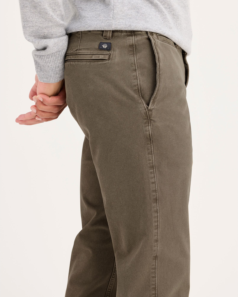 Side view of model wearing Crocodile Stonewash Men's Slim Fit Smart 360 Flex California Chino Pants.