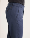 Side view of model wearing Crown Blue Men's Slim Fit Original Chino Pants.