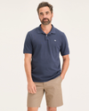 Front view of model wearing Crown Blue Men's Slim Fit Pique Polo.