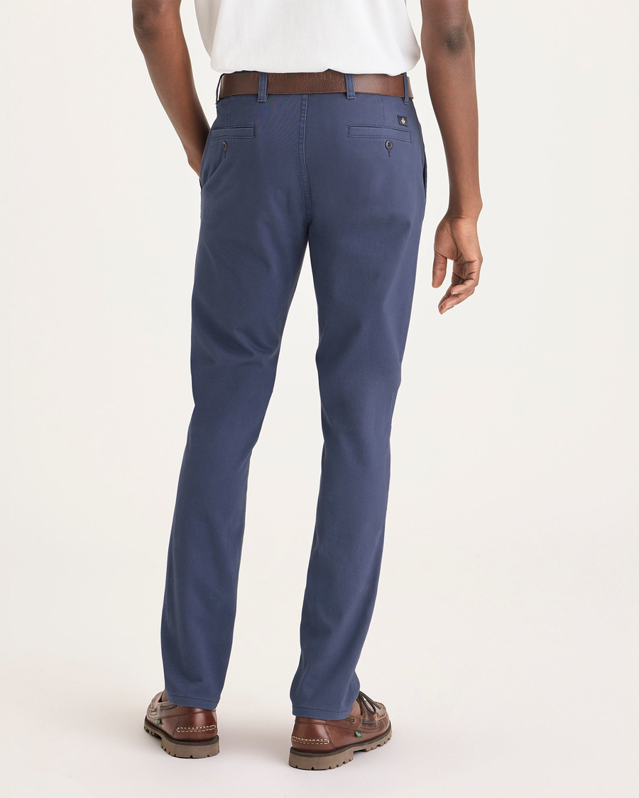 Back view of model wearing Crown Blue Men's Smart 360 Flex Ultimate Chino.