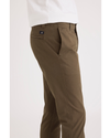 Side view of model wearing Cub Men's Skinny Fit Smart 360 Flex California Chino Pants.