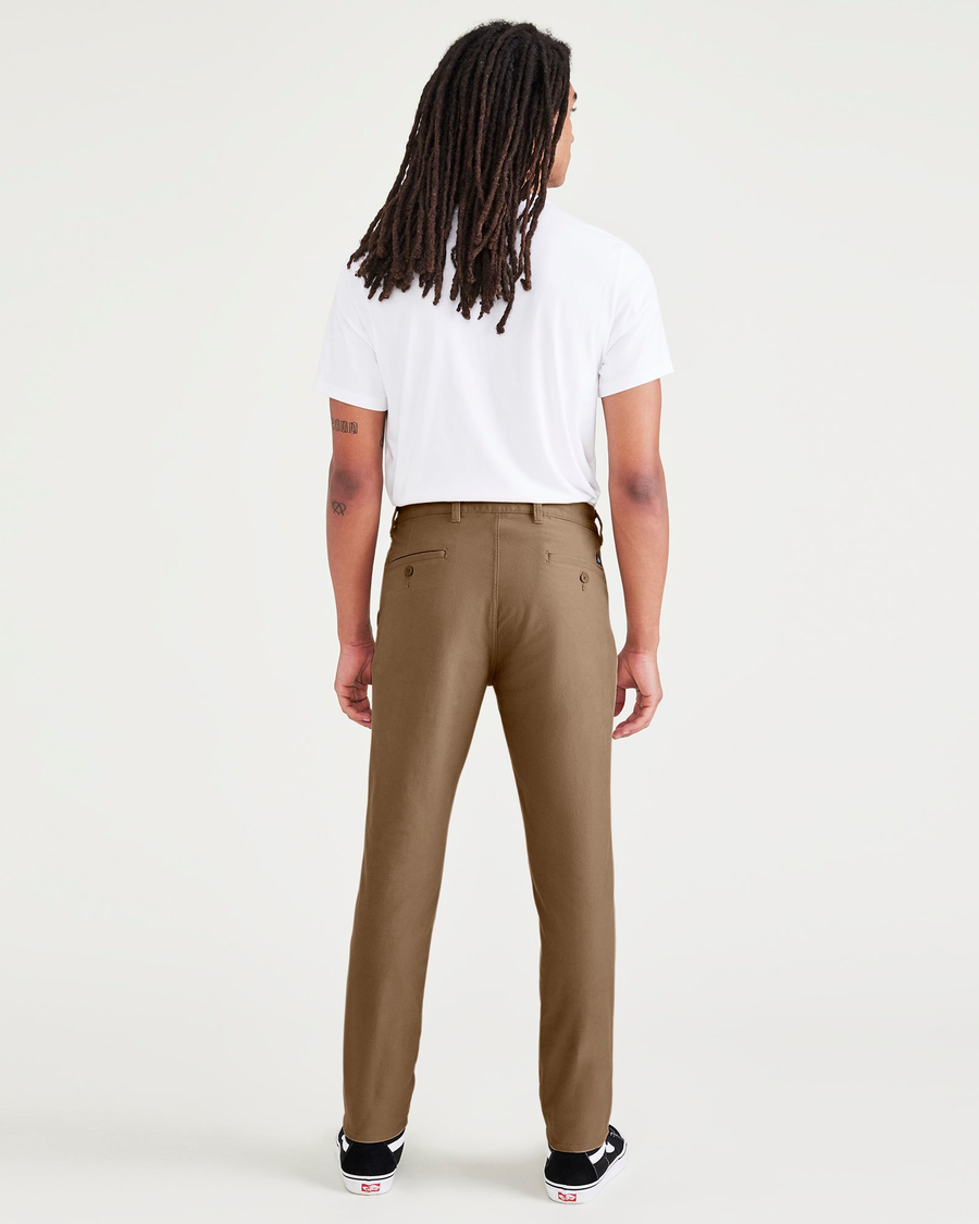 Back view of model wearing Cub Men's Skinny Fit Smart 360 Knit Chino Pants.