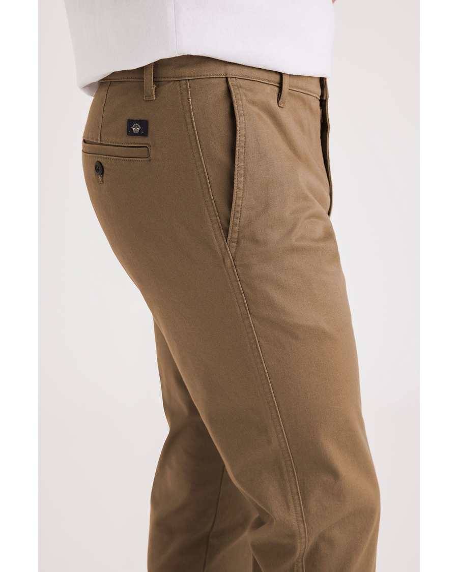 Side view of model wearing Cub Men's Slim Fit Original Chino Pants.