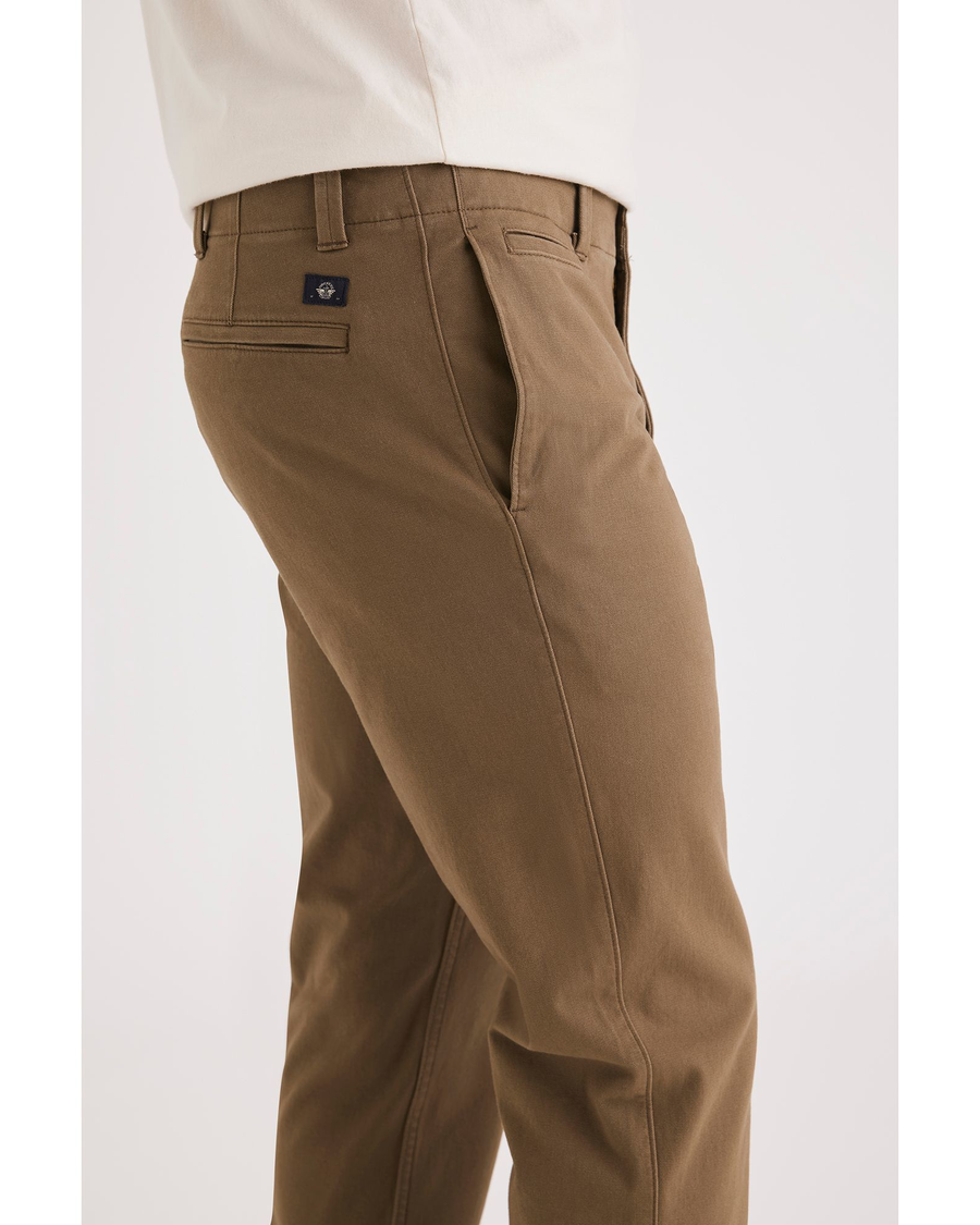 Side view of model wearing Cub Men's Slim Fit Smart 360 Flex California Chino Pants.