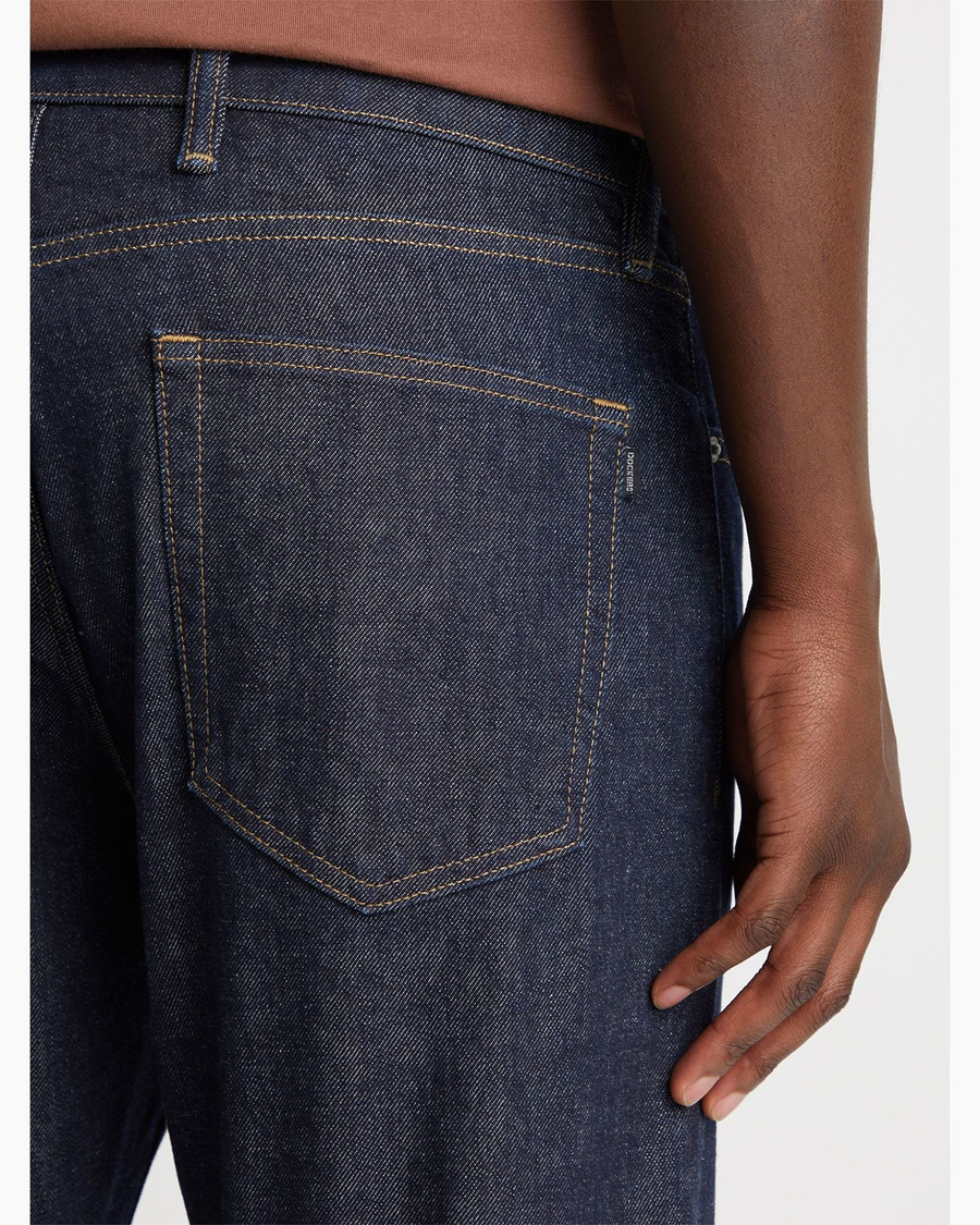 View of model wearing Dark Indigo Rinse Big and Tall Tapered Fit Original Jean Cut Pants.