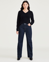 Front view of model wearing Dark Indigo Stonewash Women's Relaxed Fit Mid-Rise Jeans.