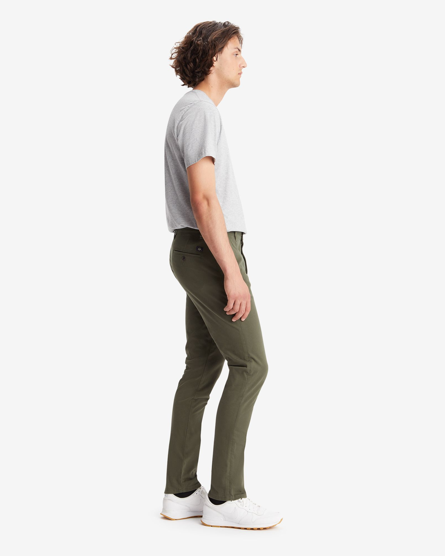 Side view of model wearing Deep Depths Men's Skinny Fit Supreme Flex Alpha Khaki Pants.