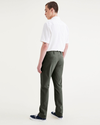 Back view of model wearing Deep Forest Alpha Chino Pants, Slim Fit.