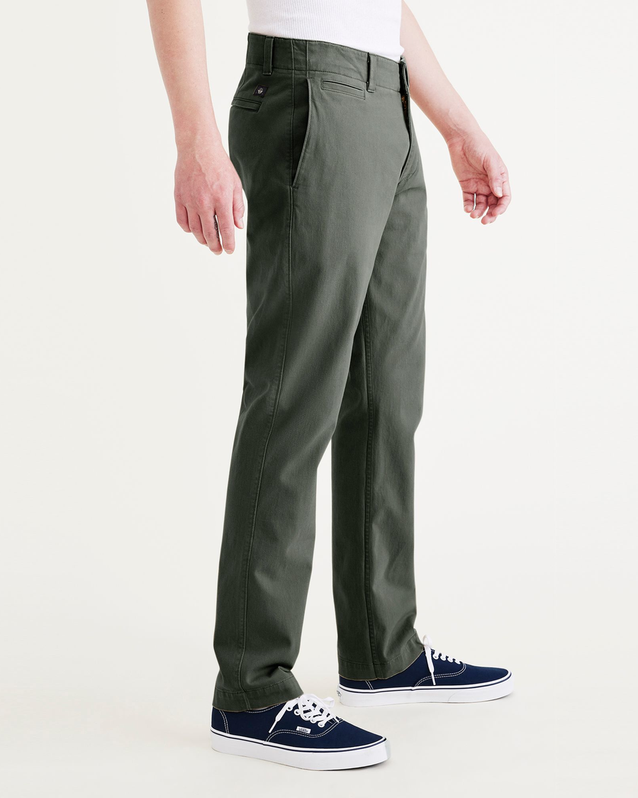 Side view of model wearing Deep Forest Alpha Chino Pants, Slim Fit.