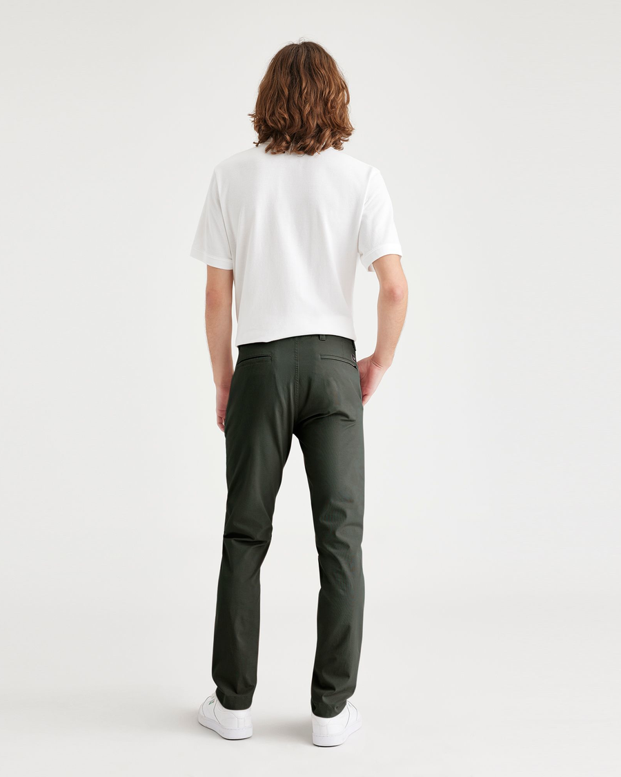 Back view of model wearing Deep Forest Men's Skinny Fit Smart 360 Flex California Chino Pants.