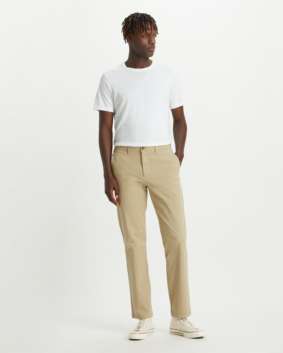 Front view of model wearing Dockers Khaki Men's Slim Fit Smart 360 Flex Alpha Chino Pants.
