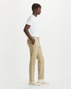 Side view of model wearing Dockers Khaki Men's Slim Fit Smart 360 Flex Alpha Chino Pants.