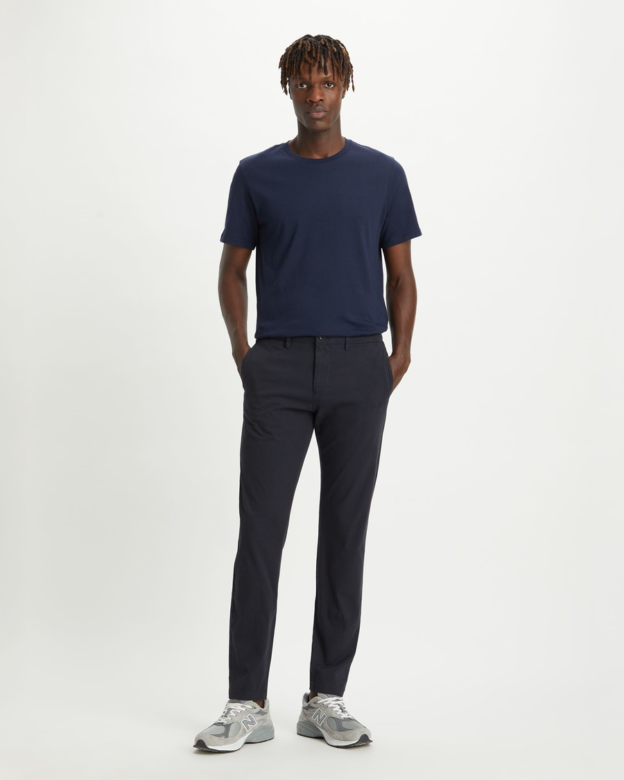 Front view of model wearing Dockers Navy Crafted Khaki Pants, Slim Tapered Fit.