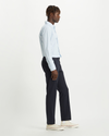 Side view of model wearing Dockers Navy Men's Slim Fit Smart 360 Flex Alpha Chino Pants.