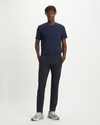 Front view of model wearing Dockers Navy Men's Slim Tapered Fit Smart 360 Flex Alpha Chino Pants.