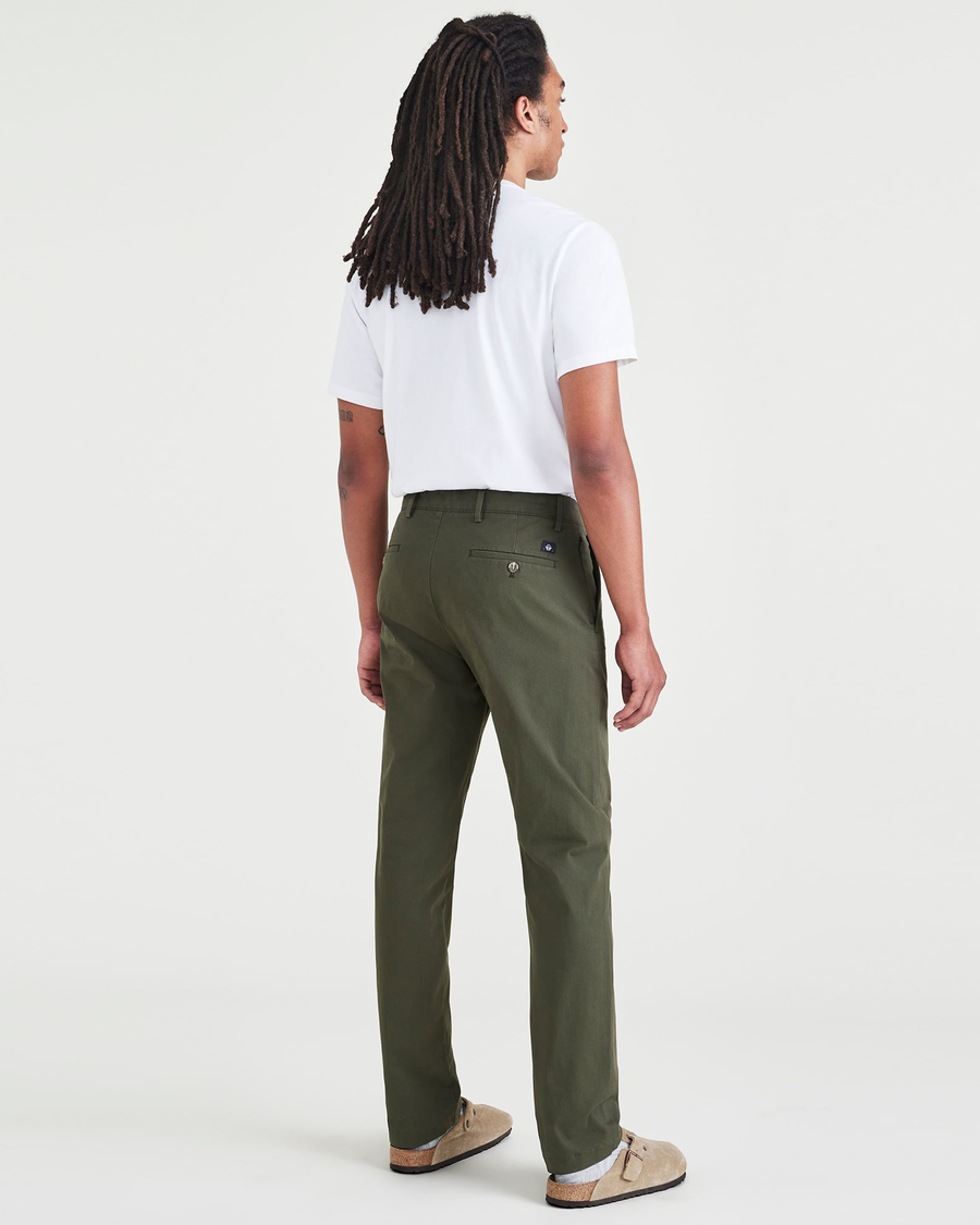 Back view of model wearing Dockers Olive Men's Slim Fit Smart 360 Flex Alpha Chino Pants.