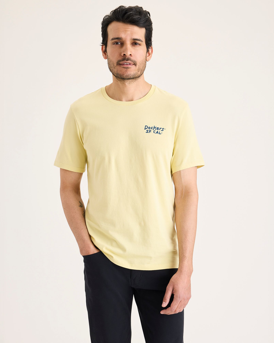 Front view of model wearing Dusty Yellow Men's Slim Fit Logo Tee.