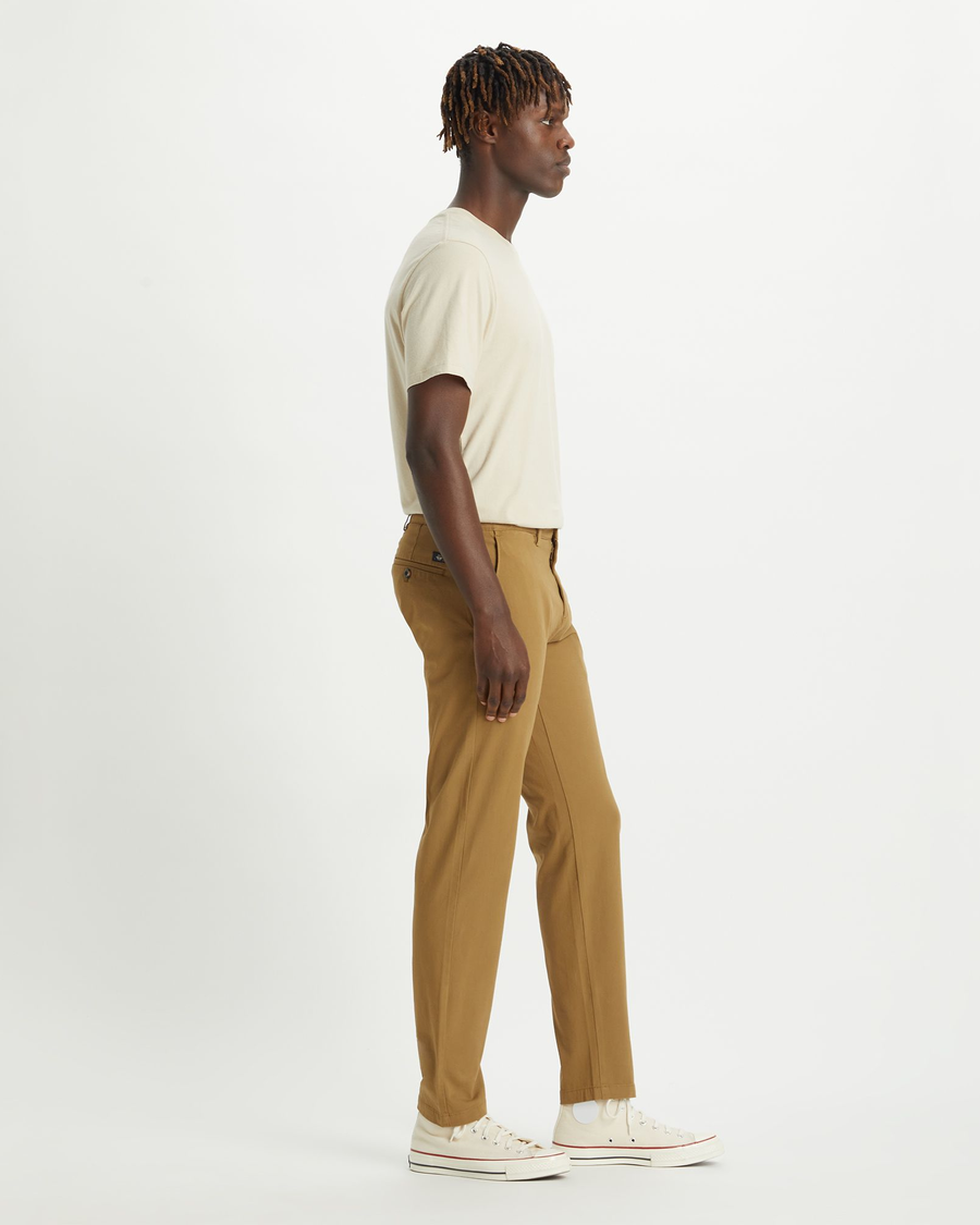 Side view of model wearing Ermine Men's Slim Tapered Fit Smart 360 Flex Alpha Chino Pants.