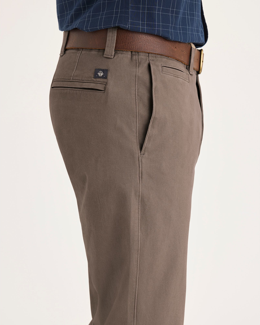 Side view of model wearing Fossil Alpha Chino Pants, Slim Fit.