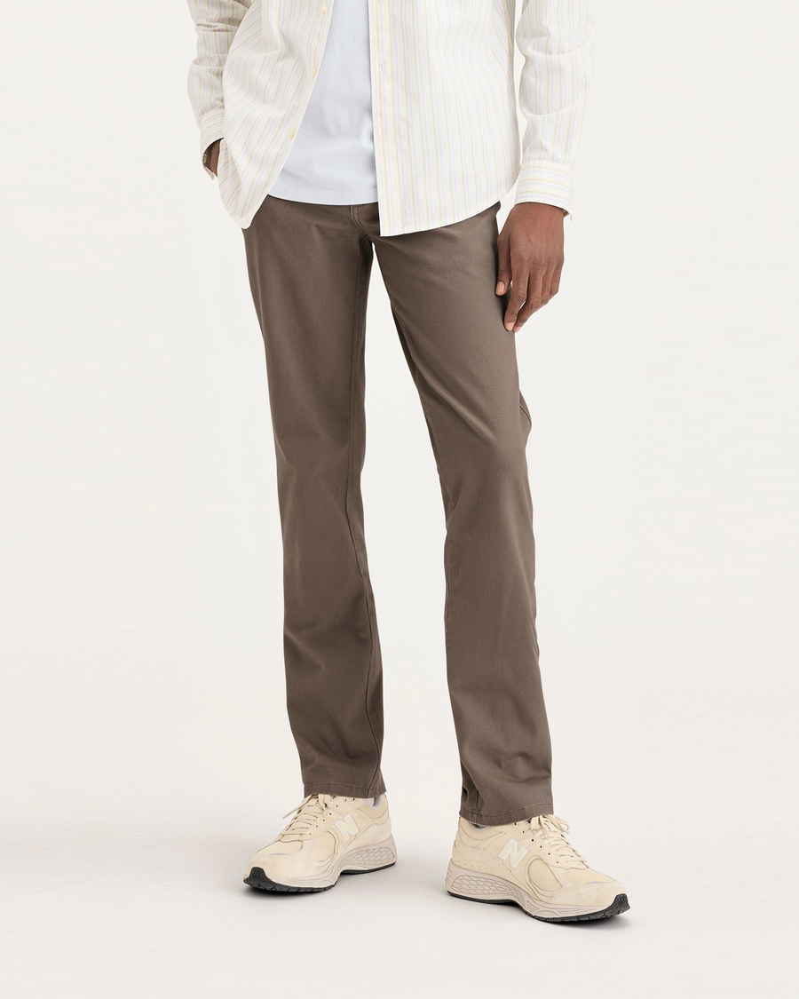 Front view of model wearing Fossil Men's Slim Fit Smart 360 Flex Ultimate Chino Pants.