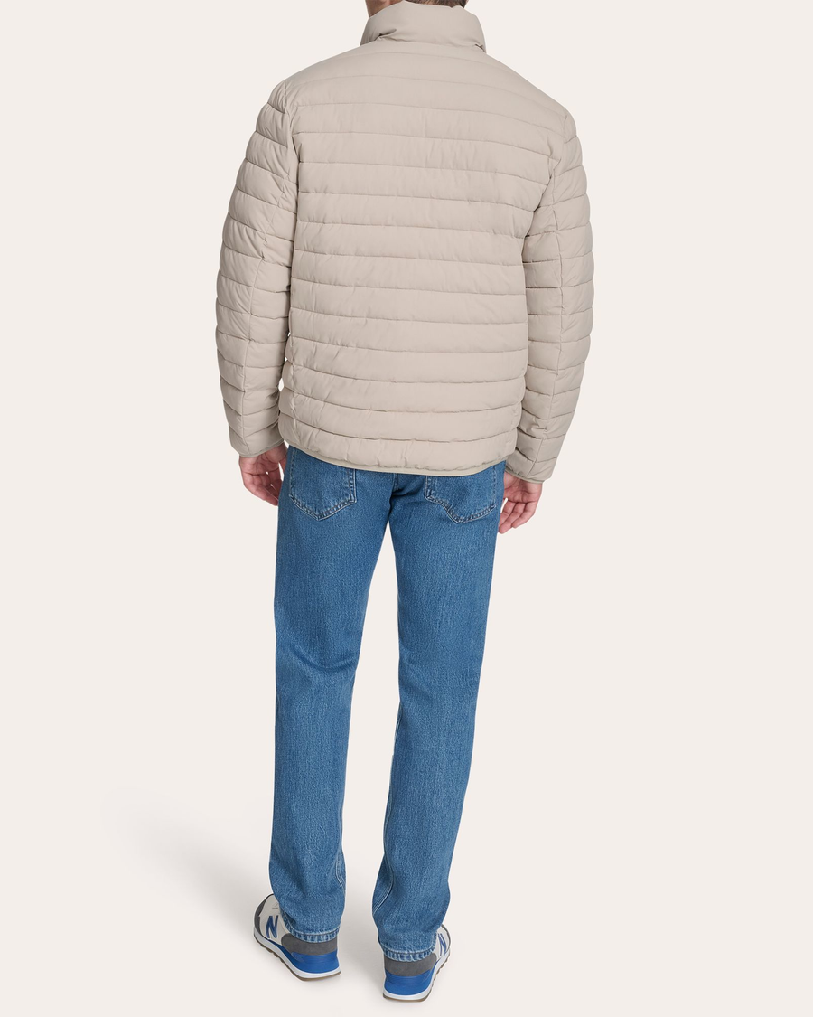 Back view of model wearing Grit Men's Packable Jacket.