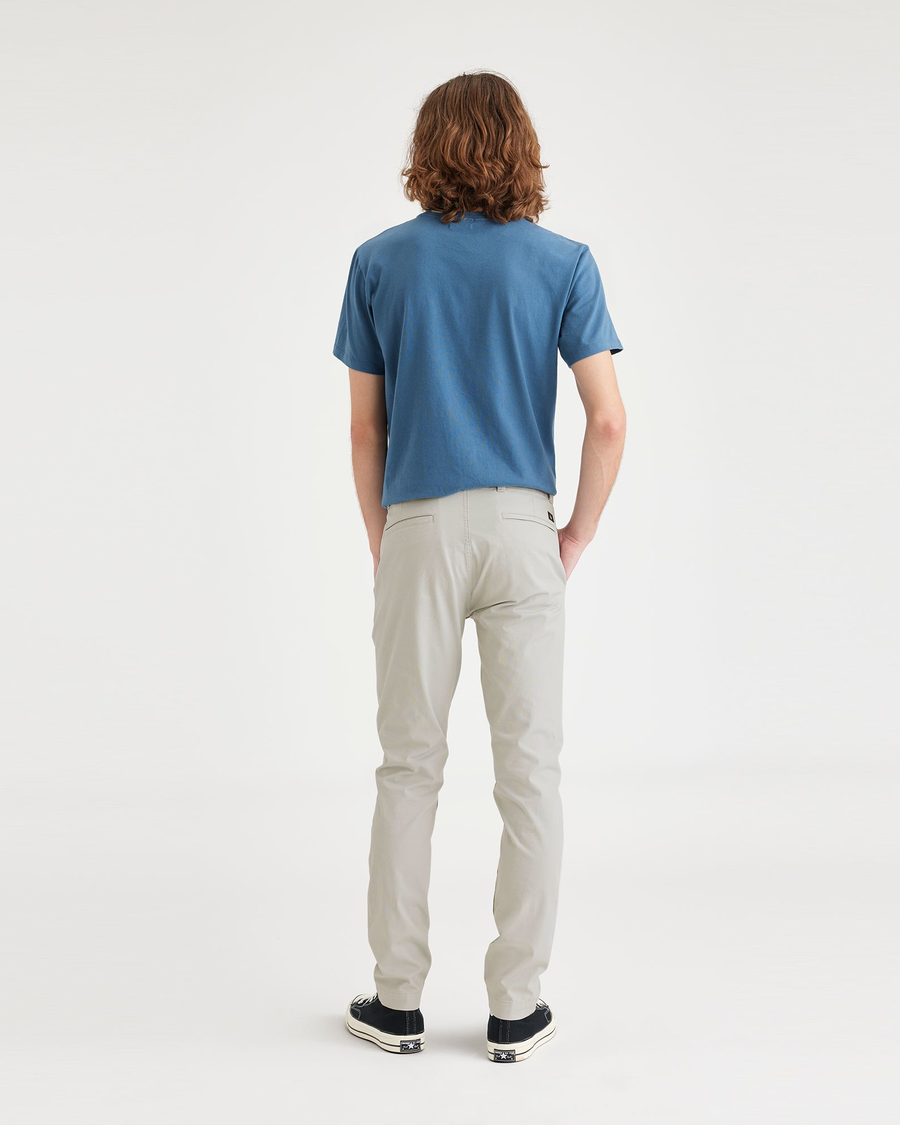 Back view of model wearing Grit Men's Skinny Fit Smart 360 Flex California Chino Pants.