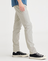 Side view of model wearing Grit Men's Skinny Fit Smart 360 Flex California Chino Pants.