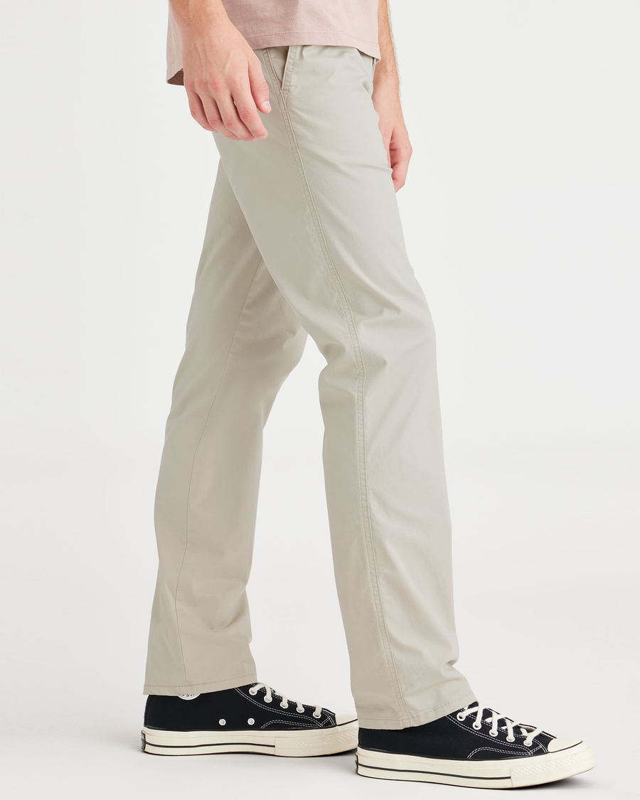 Side view of model wearing Grit Men's Slim Fit Original Chino Pants.