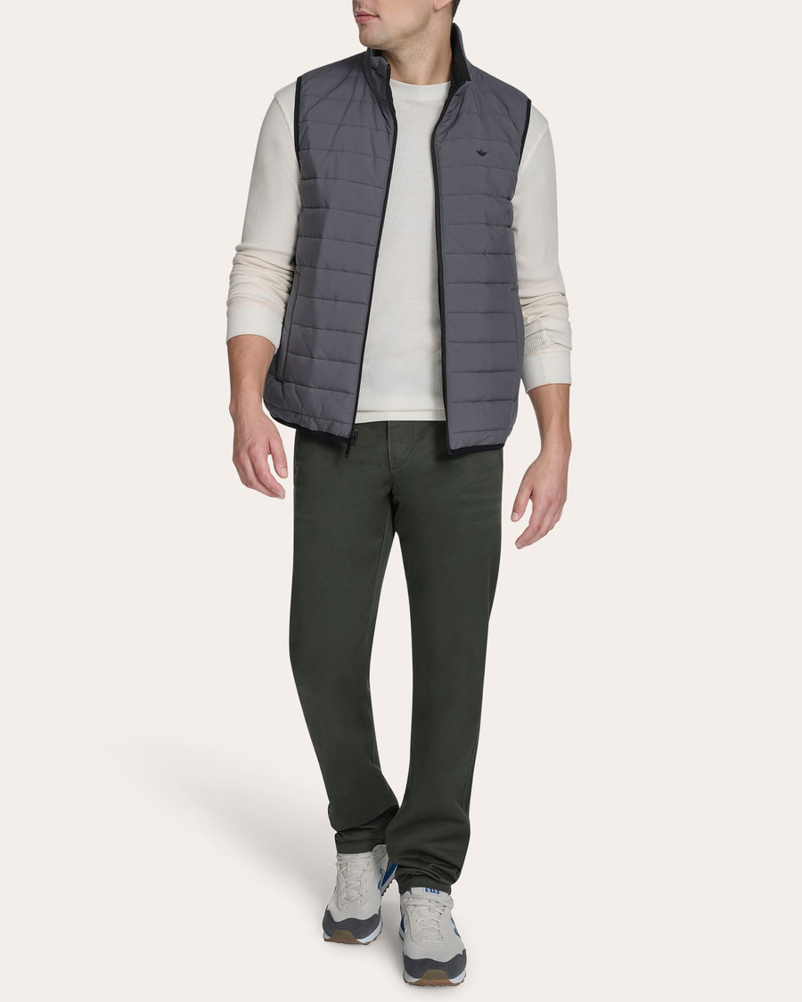 View of model wearing Grit Reversible Puffer Vest.