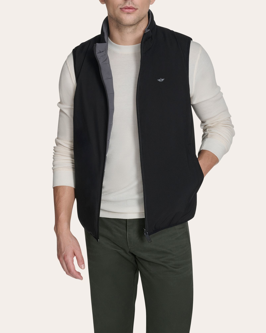 Front view of model wearing Grit Reversible Puffer Vest.