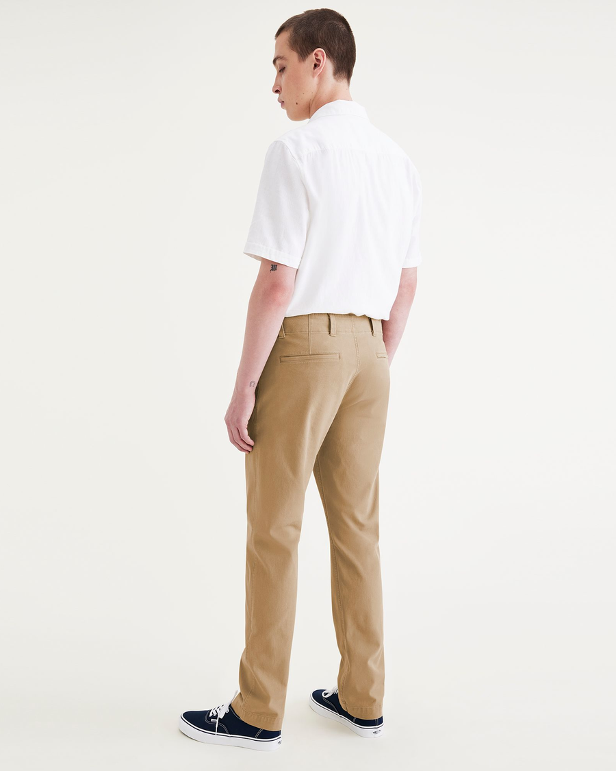 Back view of model wearing Harvest Gold Alpha Chino Pants, Slim Fit.