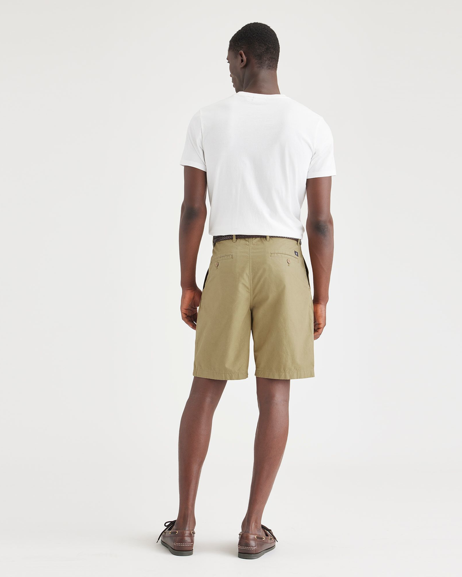 Back view of model wearing Harvest Gold Men's Classic Fit Original Pleated Shorts.
