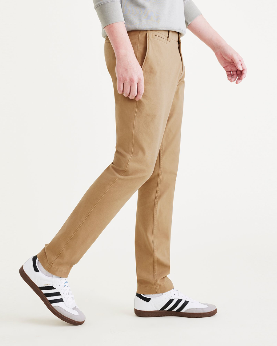 Side view of model wearing Harvest Gold Men's Skinny Fit Smart 360 Flex California Chino Pants.