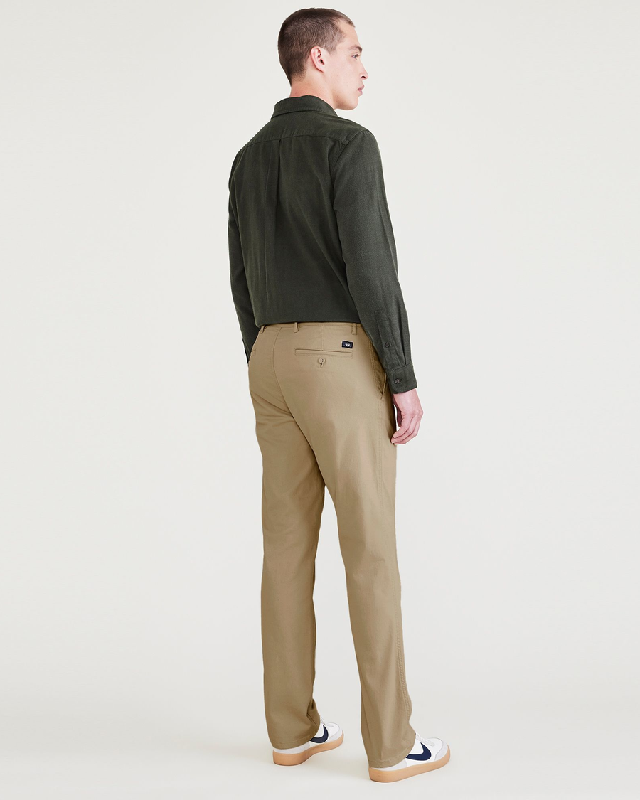 Back view of model wearing Harvest Gold Men's Slim Fit Original Chino Pants.