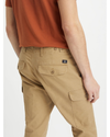 View of model wearing Harvest Gold Men's Slim Tapered Fit Cargo Pants.