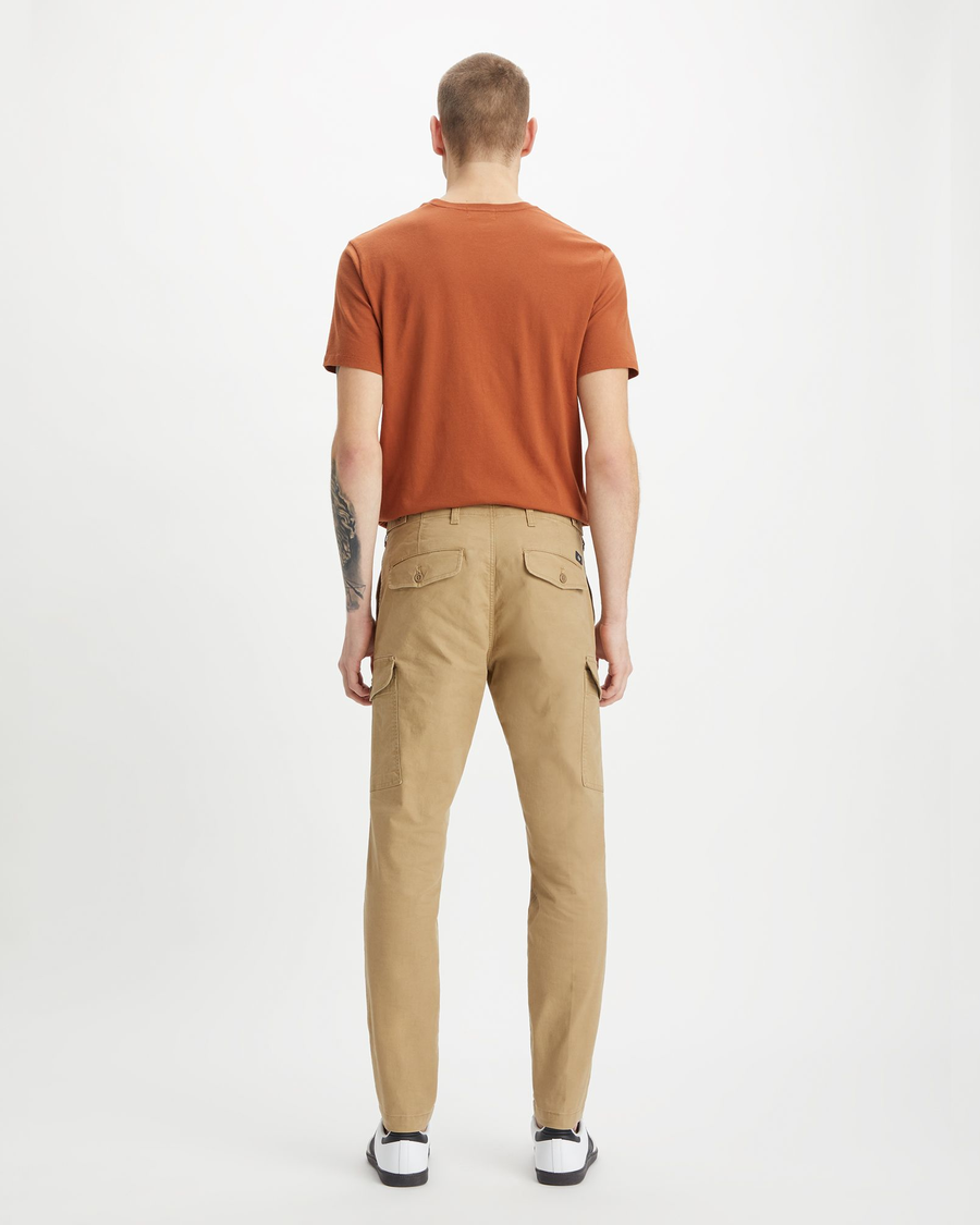 Back view of model wearing Harvest Gold Men's Slim Tapered Fit Cargo Pants.