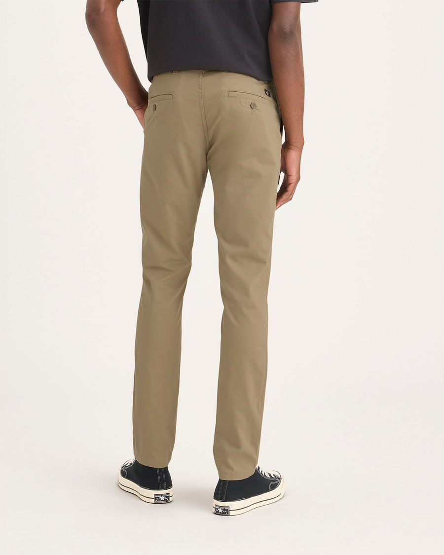 Back view of model wearing Harvest Gold Men's Smart 360 Flex Ultimate Chino.