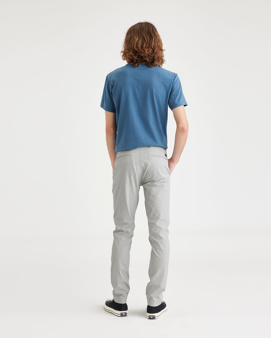 Back view of model wearing High-Rise Men's Skinny Fit Smart 360 Flex California Chino Pants.